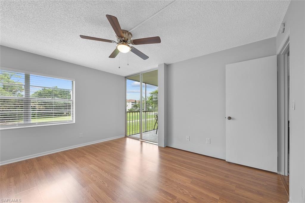 1083 Forest Lakes Drive, Unit 207 Naples, FL 34105 - Photo 14 of 21 a view of an empty room with wooden floor and a window