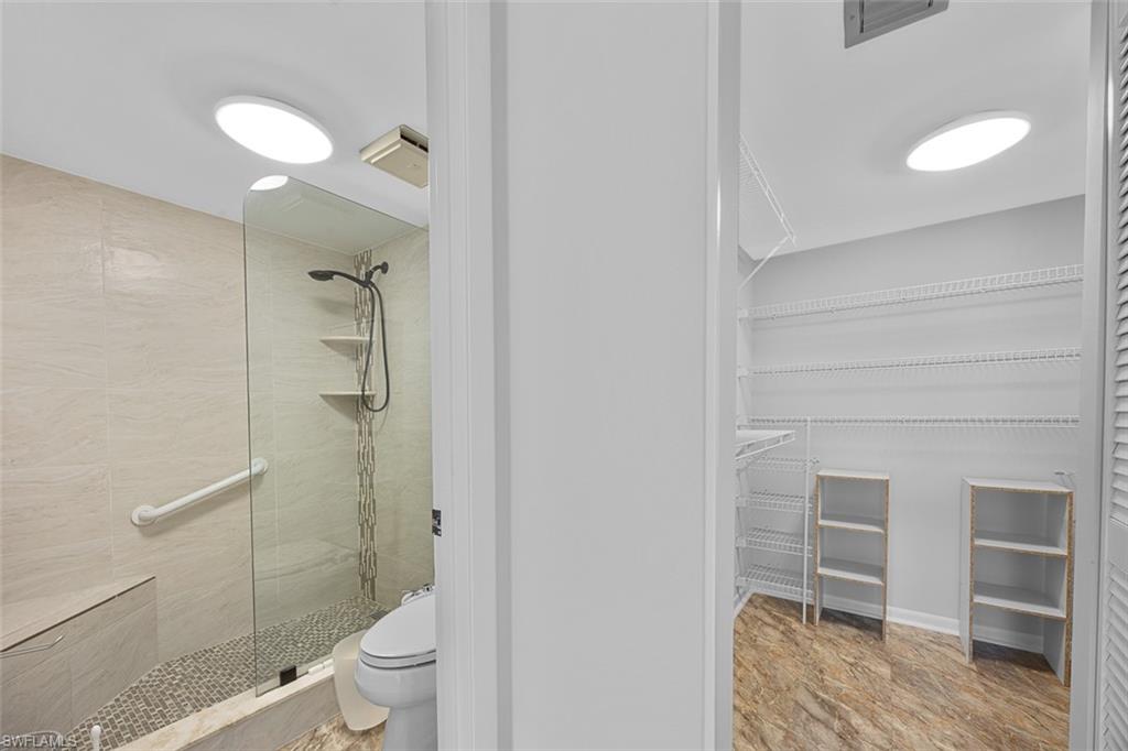 1083 Forest Lakes Drive, Unit 207 Naples, FL 34105 - Photo 18 of 21 a bathroom with a toilet and a shower