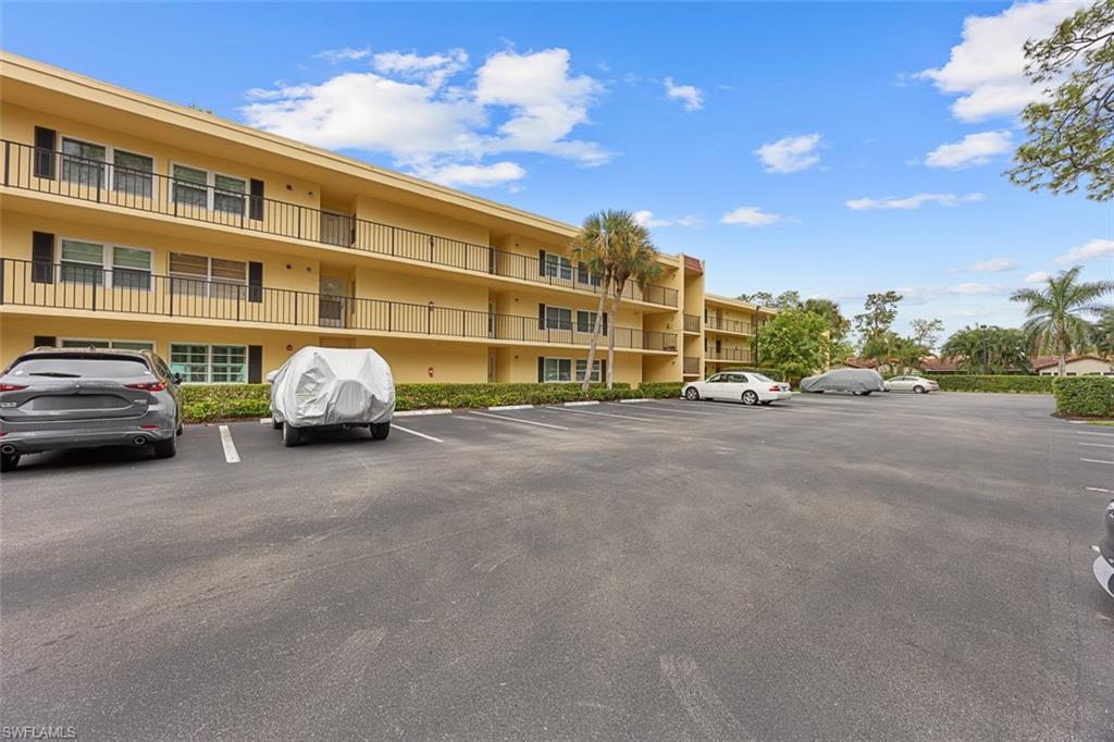 1083 Forest Lakes Drive, Unit 207 Naples, FL 34105 - Photo 21 of 21 a car parked on the side of a street