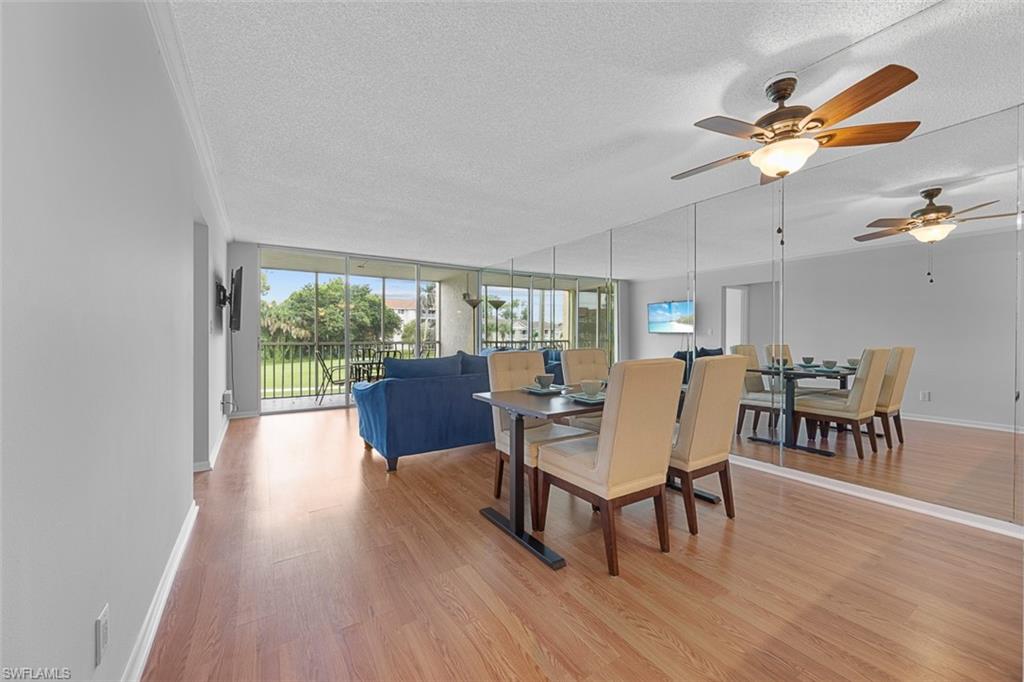 1083 Forest Lakes Drive, Unit 207 Naples, FL 34105 - Photo 10 of 21 a view of a dining room with furniture window and wooden floor