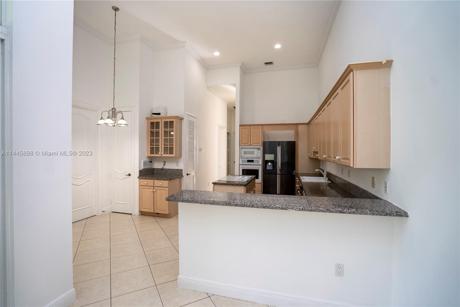 Kendall Miami, FL 33176 - Photo 12 of 28 a kitchen with stainless steel appliances granite countertop a sink and a refrigerator