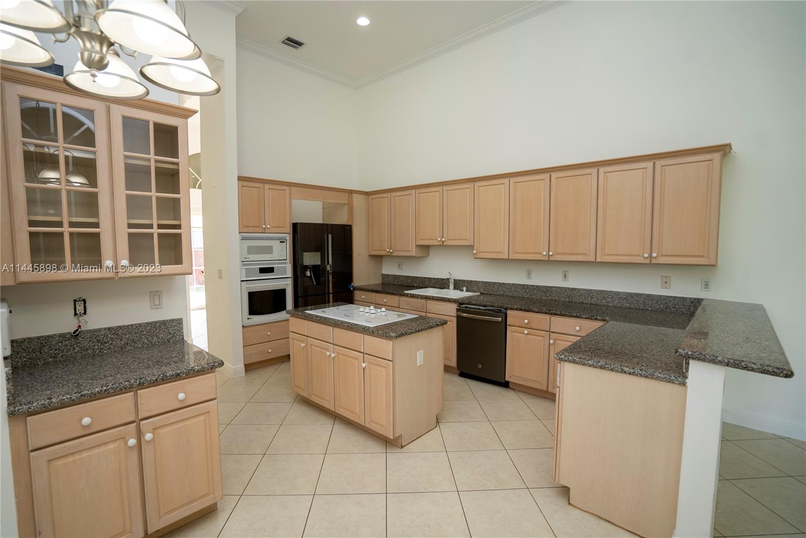 Kendall Miami, FL 33176 - Photo 14 of 28 a kitchen with stainless steel appliances granite countertop a stove and a refrigerator