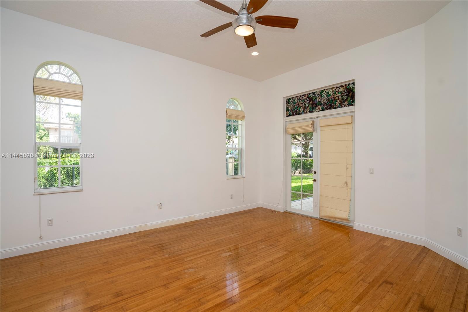 Kendall Miami, FL 33176 - Photo 18 of 28 a view of a bedroom with wooden floor and a ceiling fan