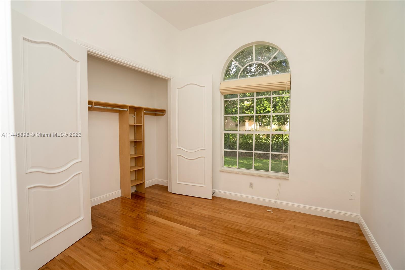 Kendall Miami, FL 33176 - Photo 20 of 28 an empty room with wooden floor cabinet and windows
