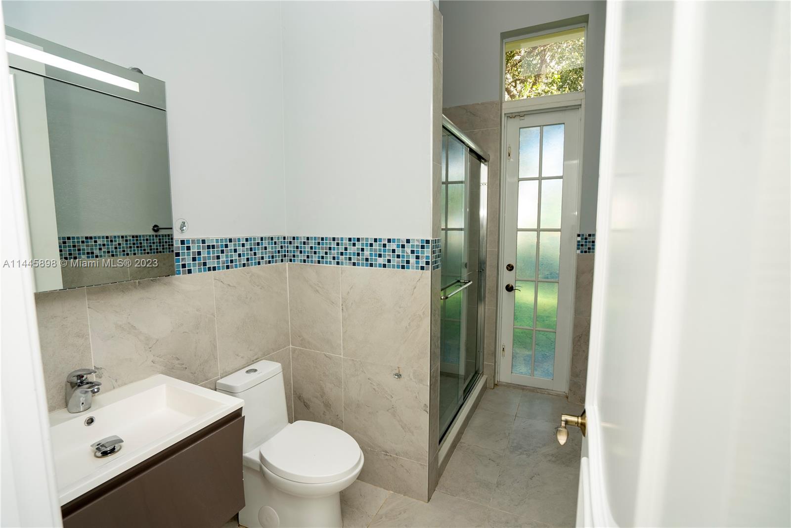 Kendall Miami, FL 33176 - Photo 22 of 28 a bathroom with a toilet a sink and mirror