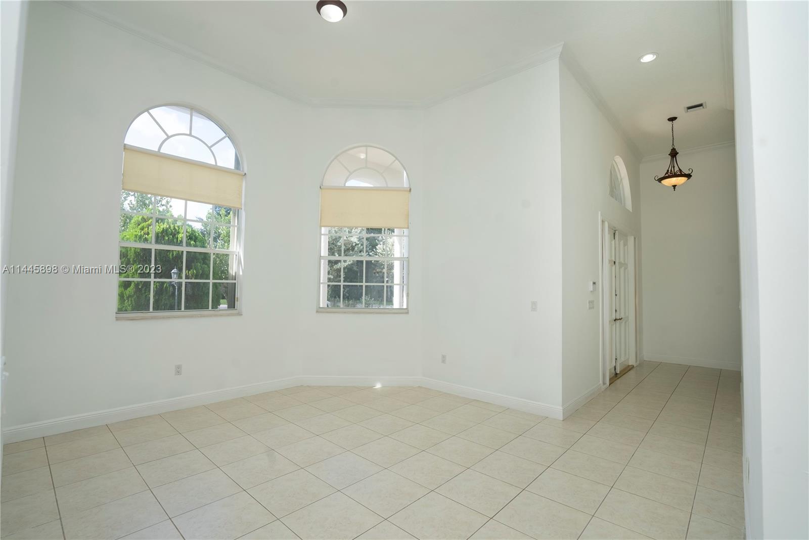 Kendall Miami, FL 33176 - Photo 10 of 28 an empty room with chandelier fan and windows