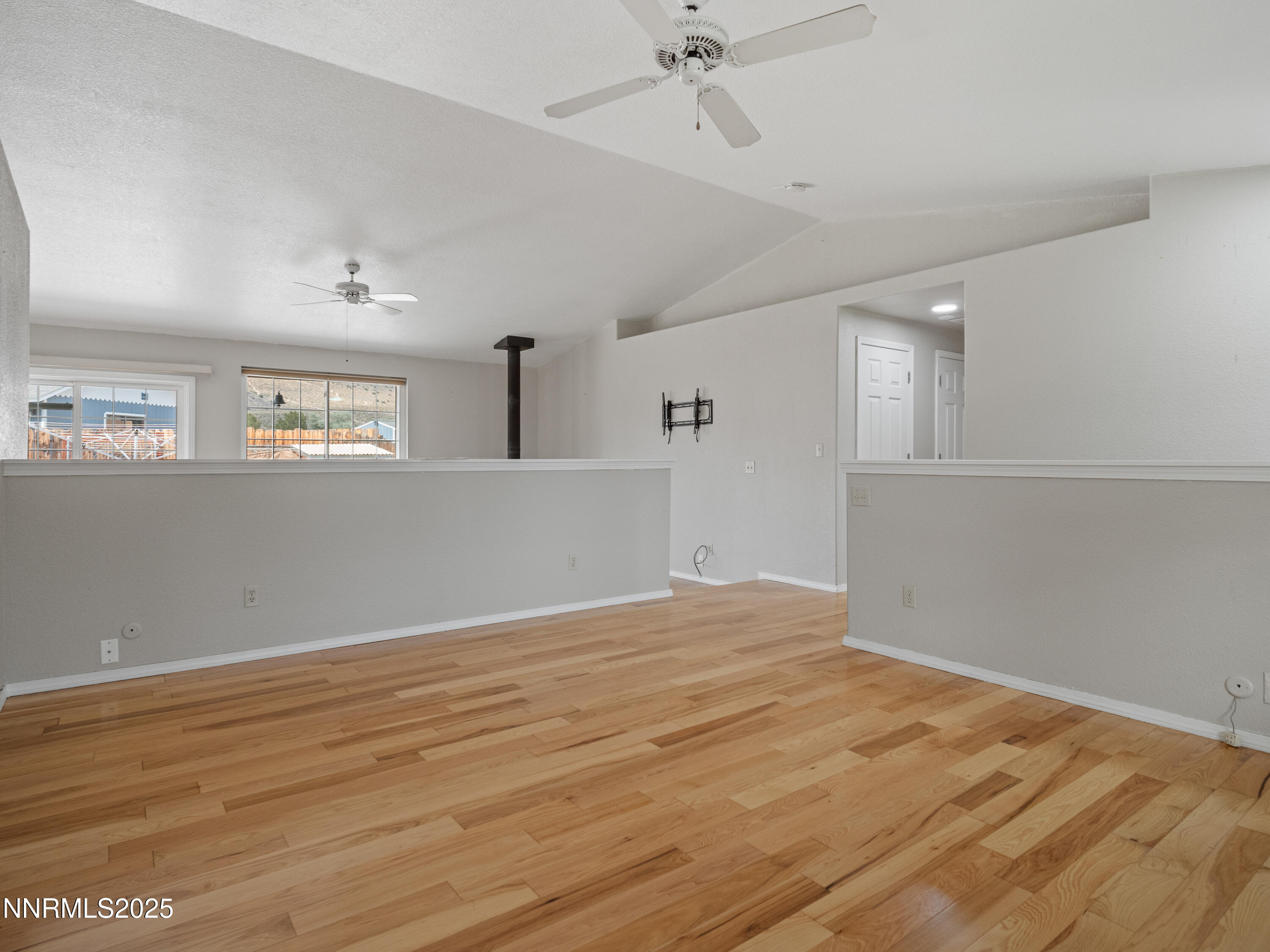 2843 Wade Street Minden, NV 89423 - Photo 25 of 74 a view of an empty room with wooden floor and a window
