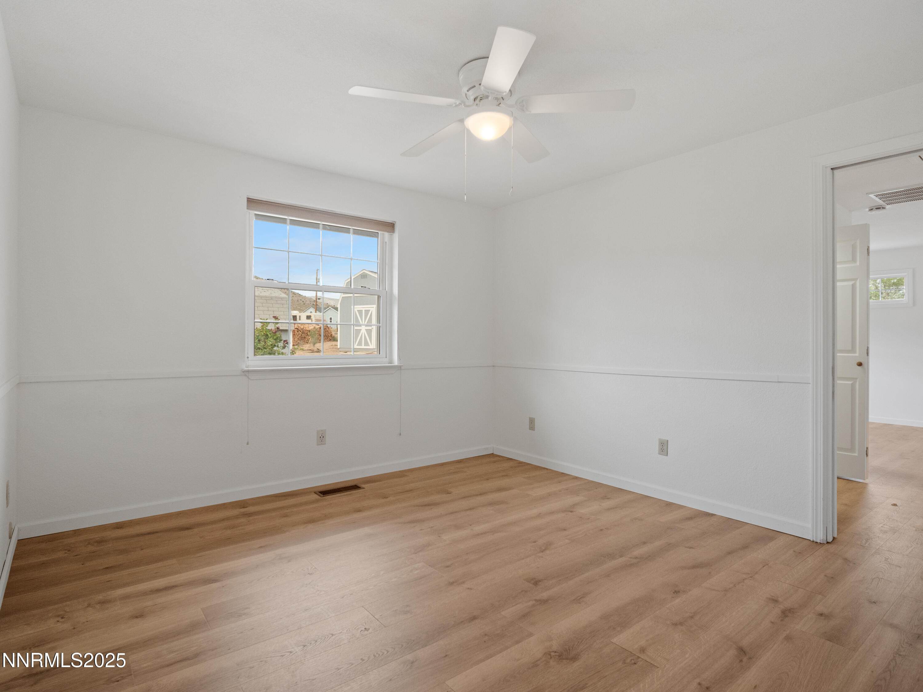 2843 Wade Street Minden, NV 89423 - Photo 49 of 74 an empty room with a ceiling fan and a window