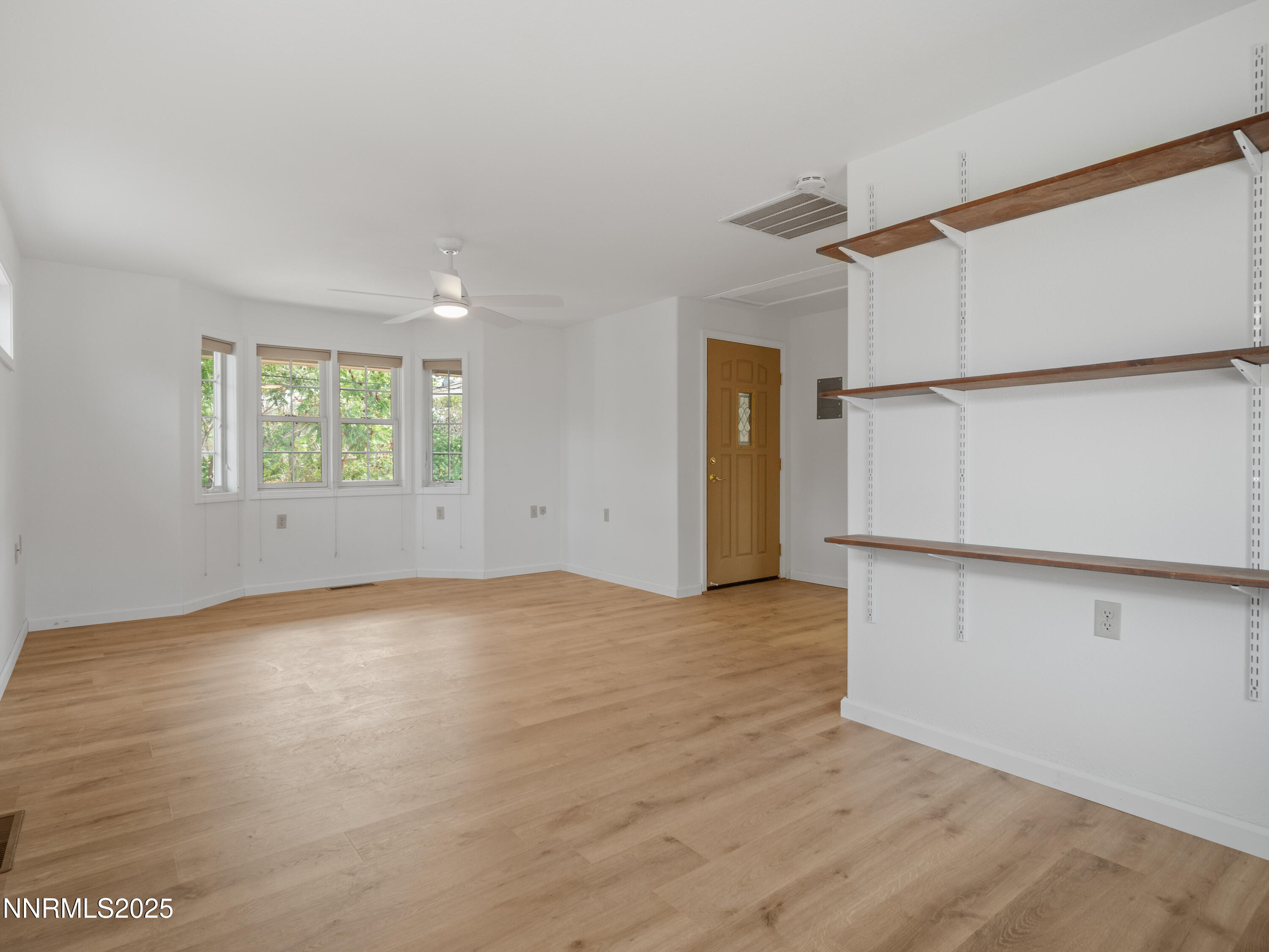 2843 Wade Street Minden, NV 89423 - Photo 56 of 74 a view of an empty room with wooden floor and a window