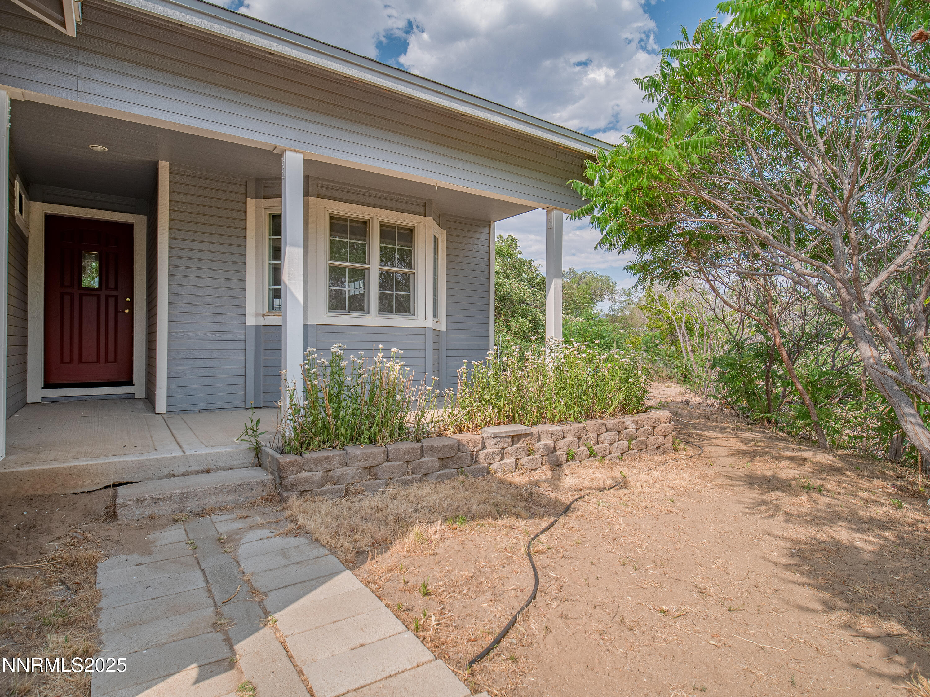 2843 Wade Street Minden, NV 89423 - Photo 67 of 74 a front view of a house with a yard and potted plants