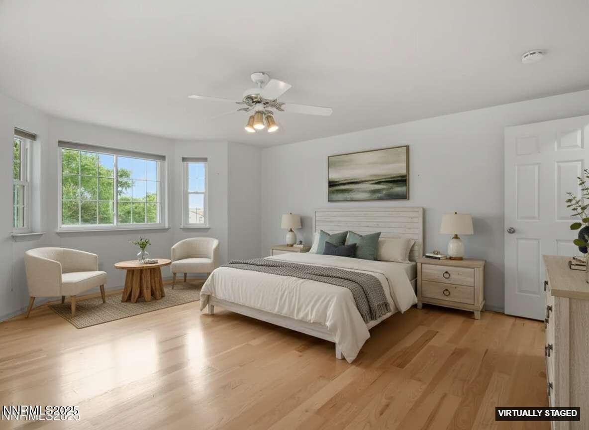 2843 Wade Street Minden, NV 89423 - Photo 7 of 74 a spacious bedroom with a bed and wooden floor