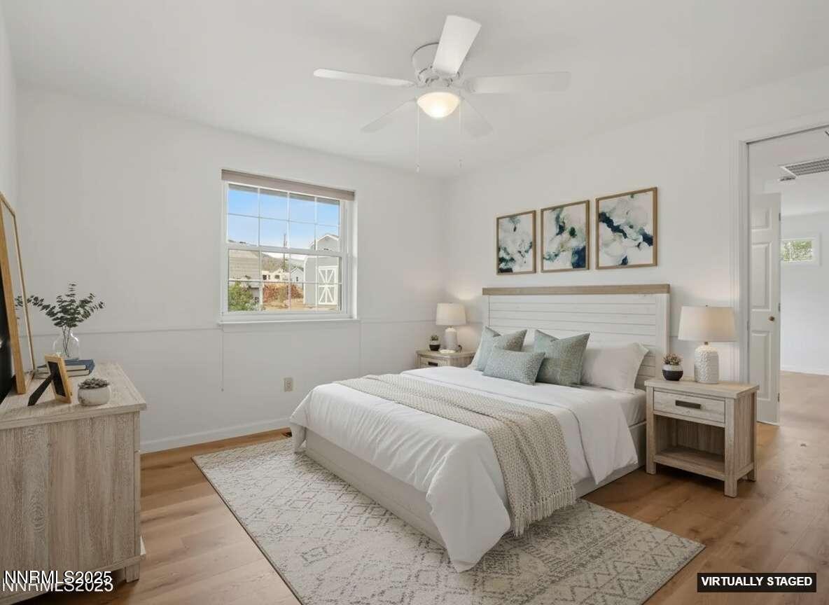 2843 Wade Street Minden, NV 89423 - Photo 9 of 74 a bedroom with a bed and a chandelier