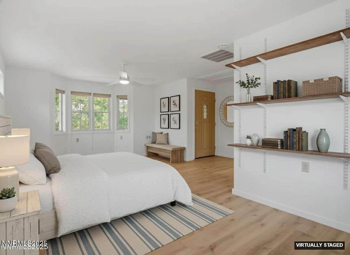 2843 Wade Street Minden, NV 89423 - Photo 10 of 74 a bedroom with a large bed and a wooden floor