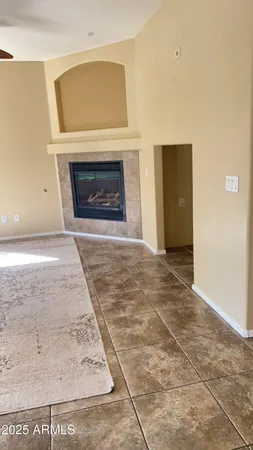 a view of empty room with a fireplace