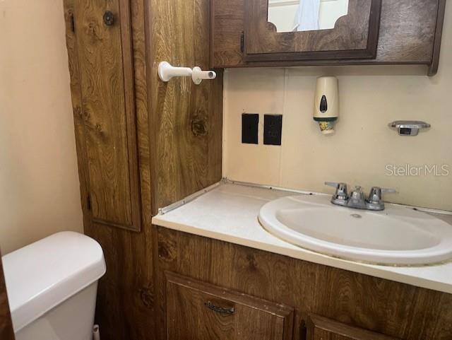 3000 Clarcona Road, Unit 438 Apopka, FL 32703 - Photo 6 of 7 a bathroom with a sink a toilet and shower