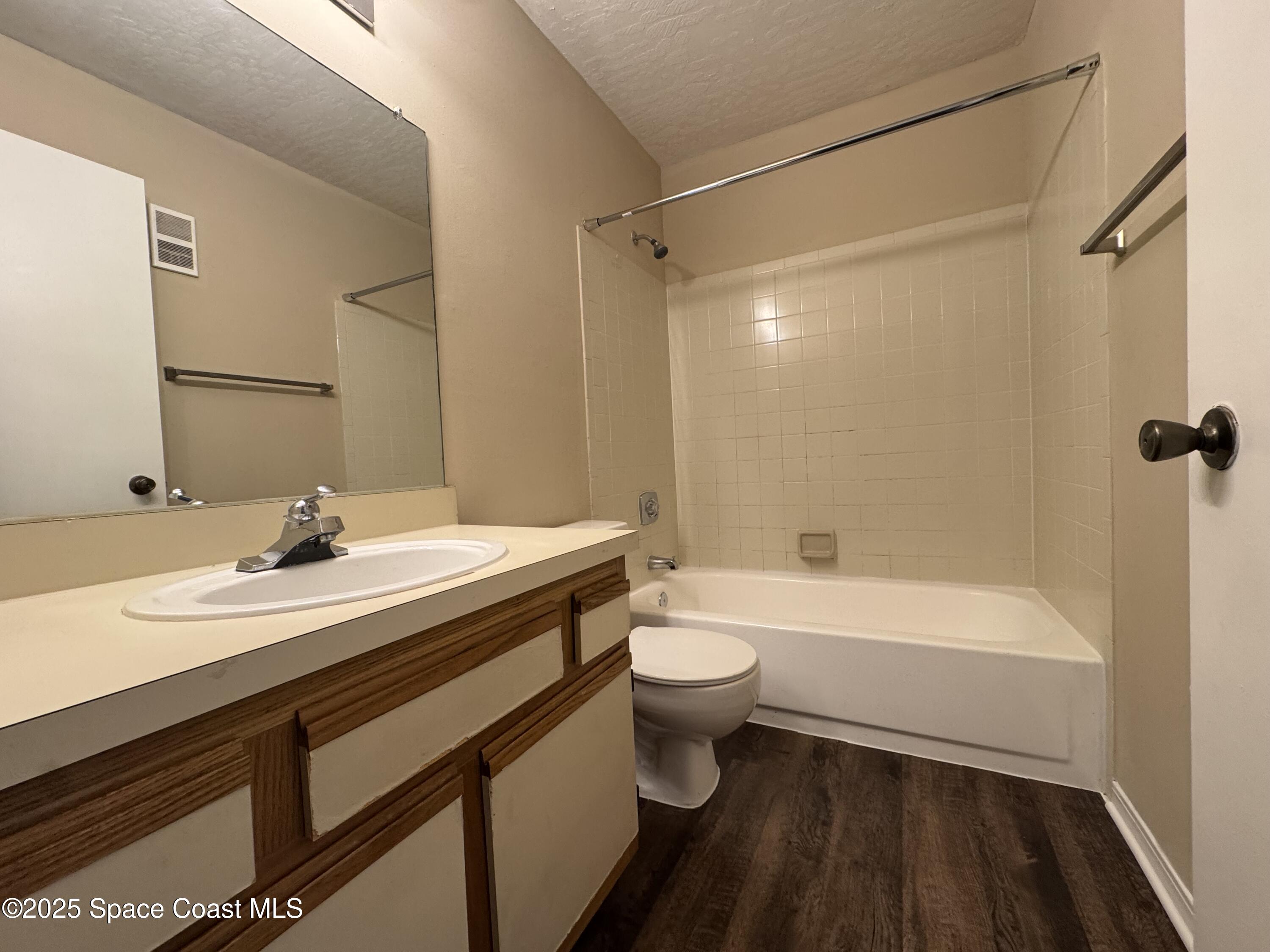 7667 North Wickham Road, Unit 1215 Melbourne, FL 32940 - Photo 11 of 31 a bathroom with a sink a toilet and a bathtub