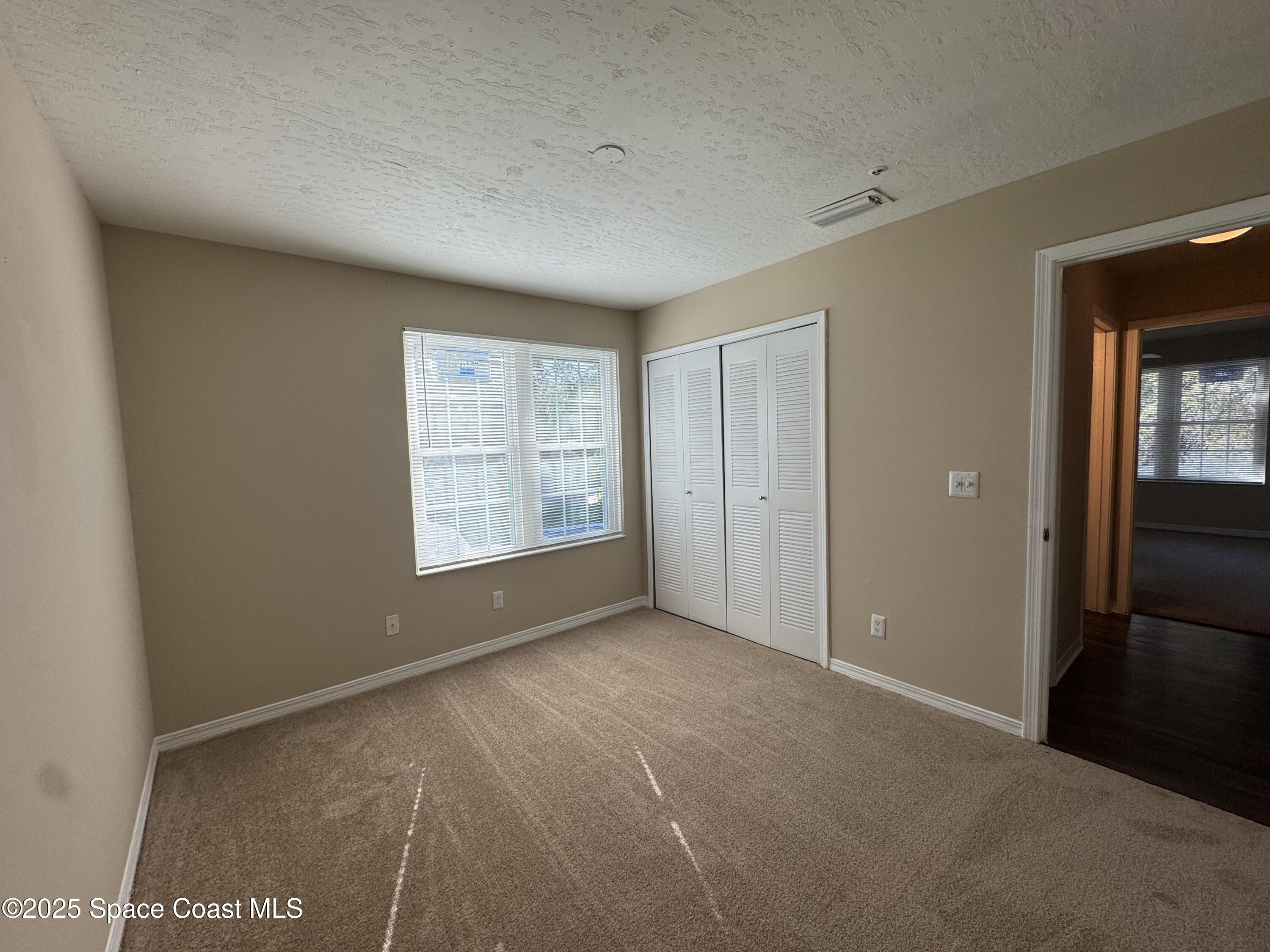 7667 North Wickham Road, Unit 1215 Melbourne, FL 32940 - Photo 13 of 31 a view of an empty room with a window