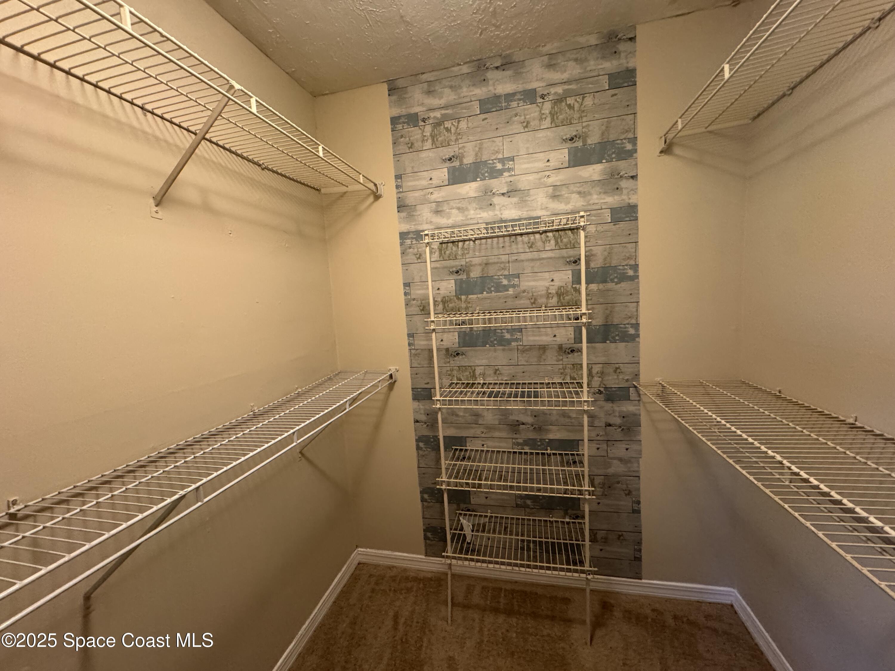 7667 North Wickham Road, Unit 1215 Melbourne, FL 32940 - Photo 13 of 32 Primary bedroom walkin closet