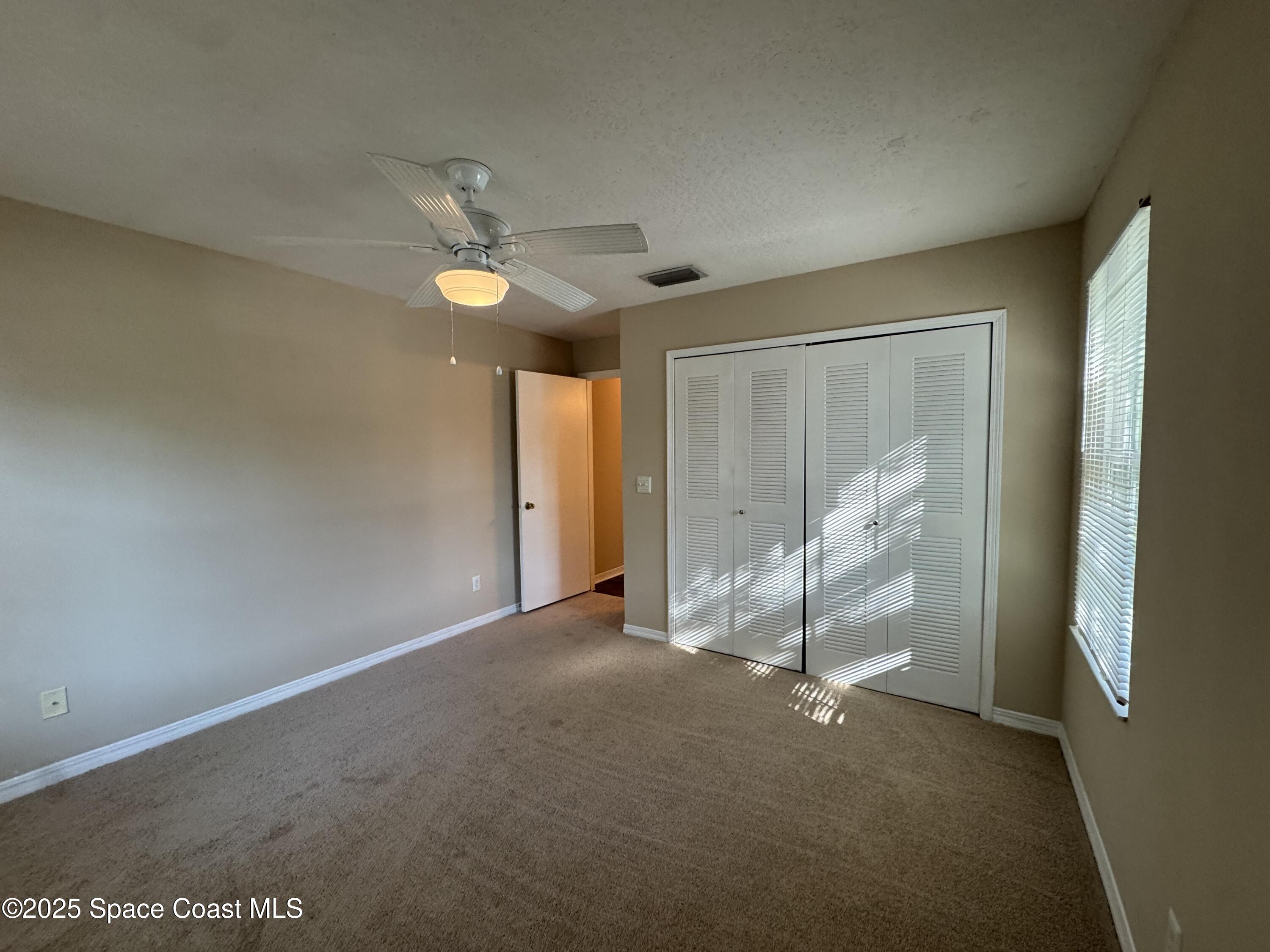 7667 North Wickham Road, Unit 1215 Melbourne, FL 32940 - Photo 15 of 31 a view of an empty room with a window