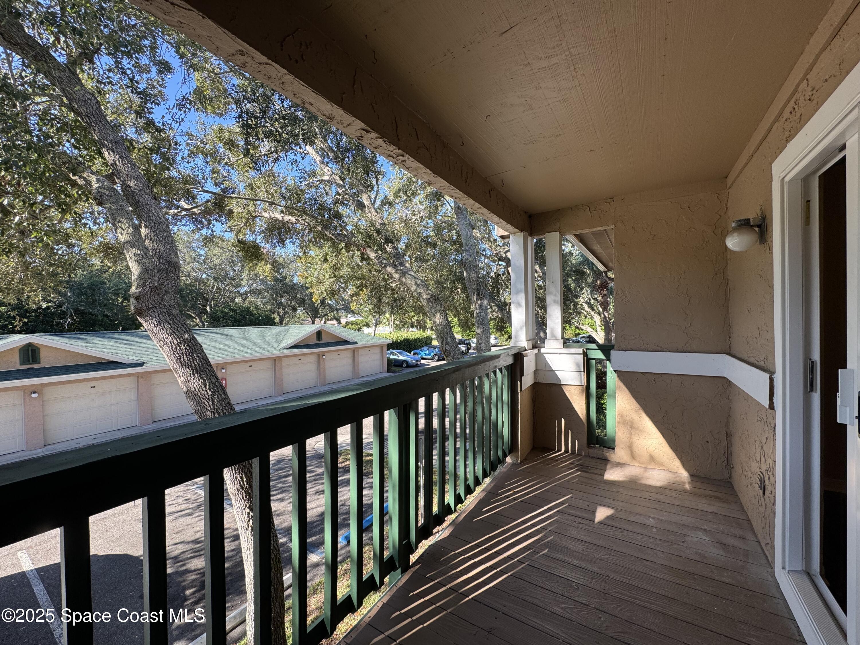 7667 North Wickham Road, Unit 1215 Melbourne, FL 32940 - Photo 17 of 31 a view of balcony with wooden floor