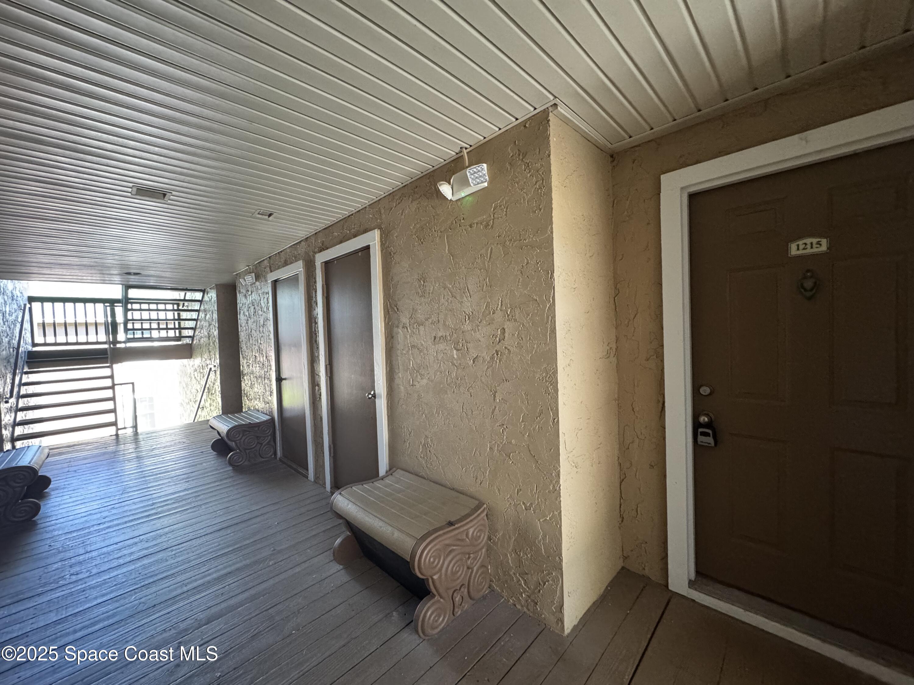 7667 North Wickham Road, Unit 1215 Melbourne, FL 32940 - Photo 18 of 31 a view of a hallway with wooden floor