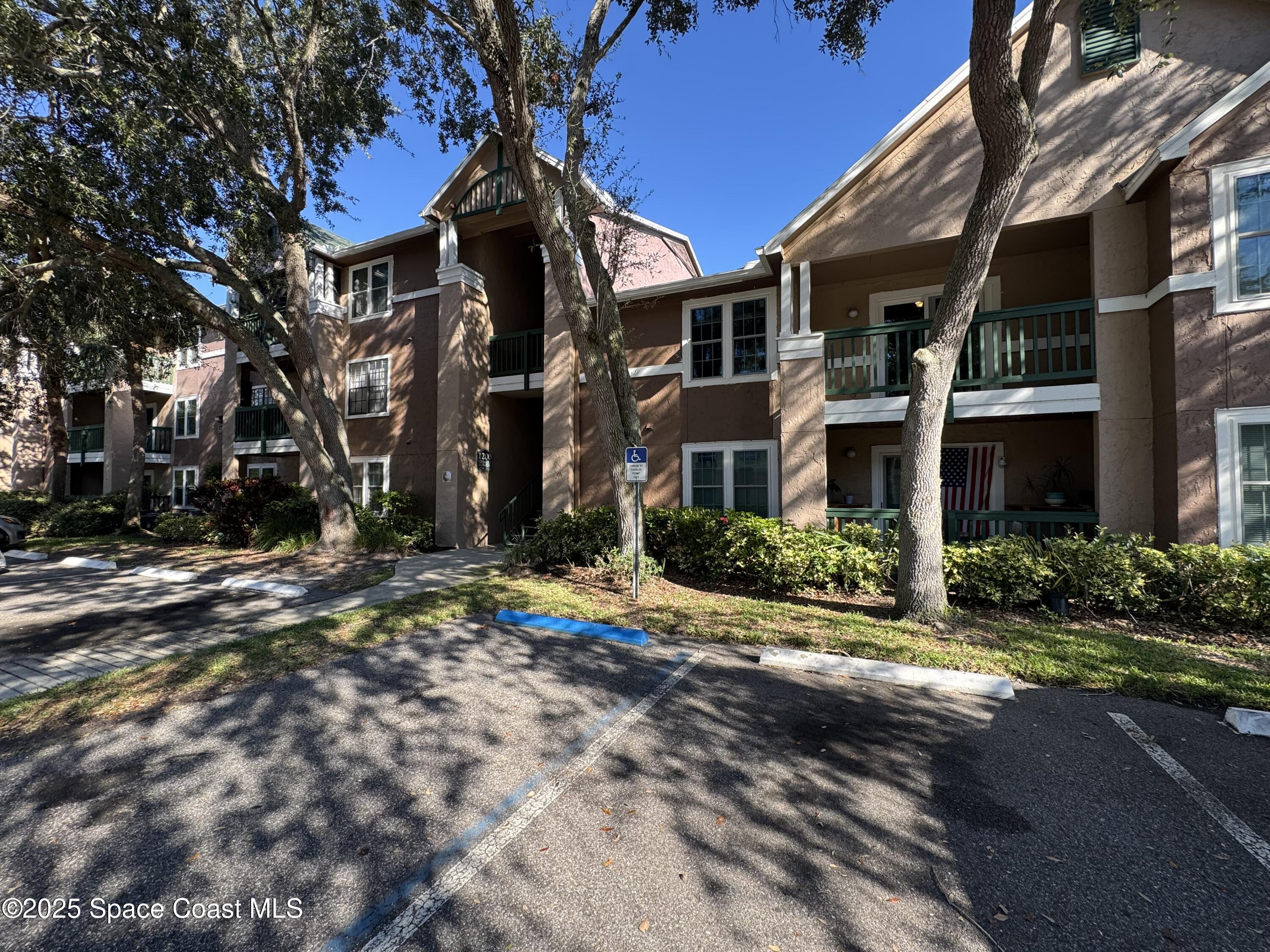 7667 North Wickham Road, Unit 1215 Melbourne, FL 32940 - Photo 20 of 31 a view of a building with a street