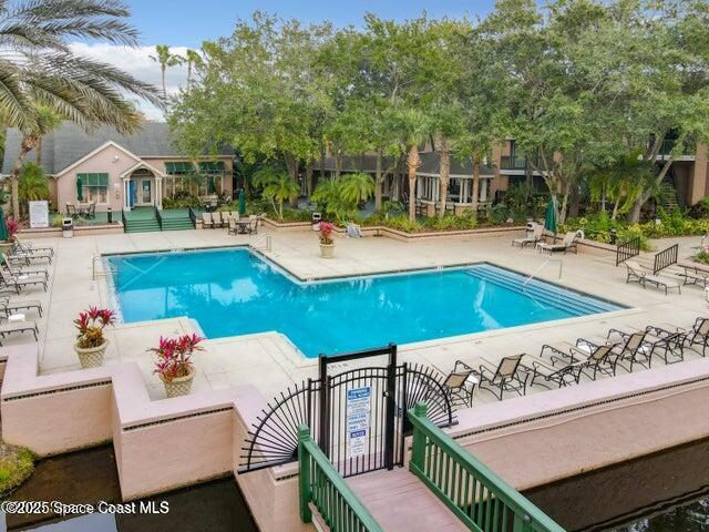 7667 North Wickham Road, Unit 1215 Melbourne, FL 32940 - Photo 23 of 31 a view of a patio with couches table and chairs and potted plants