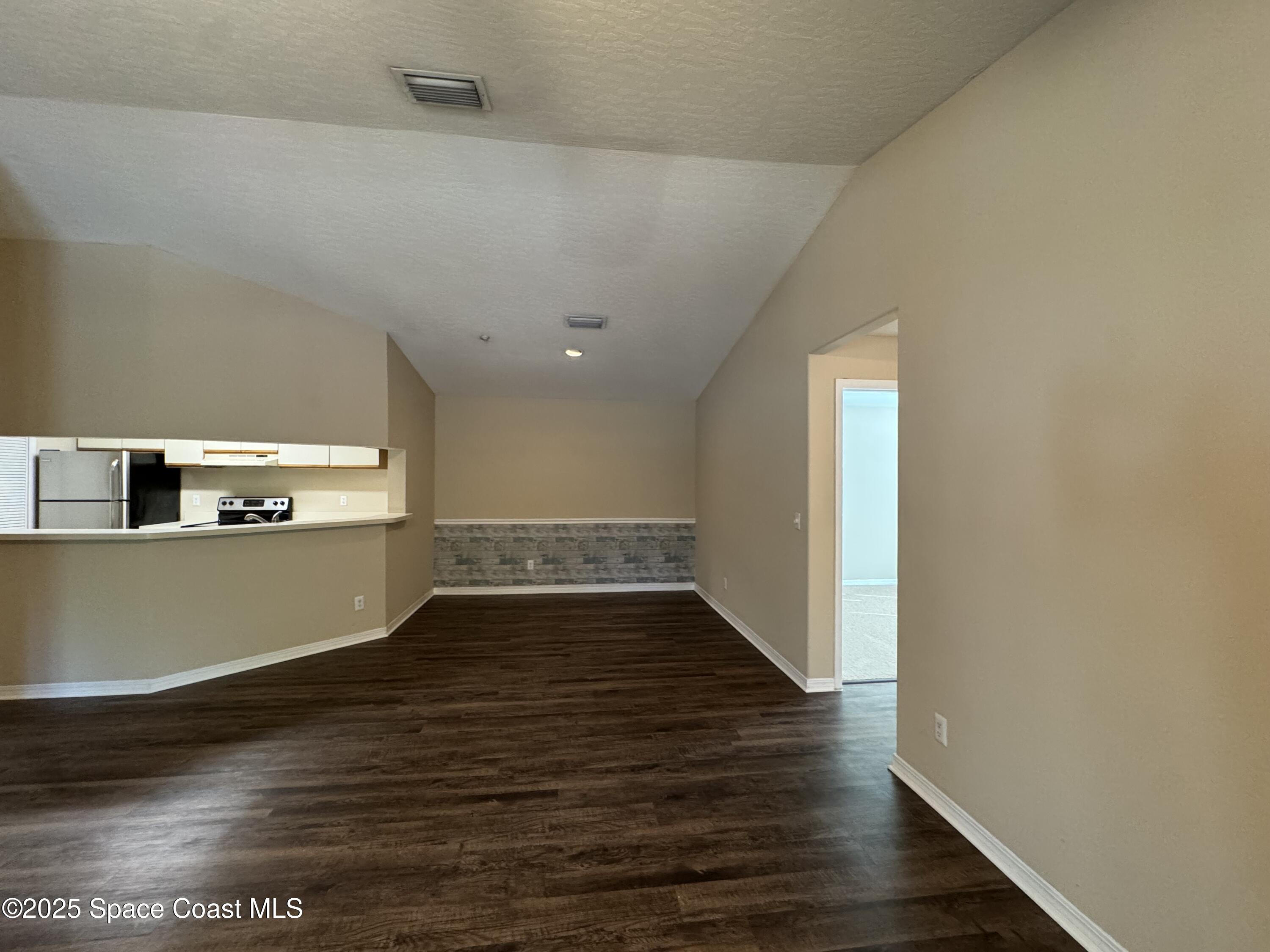 7667 North Wickham Road, Unit 1215 Melbourne, FL 32940 - Photo 6 of 31 a view of empty room with wooden floor