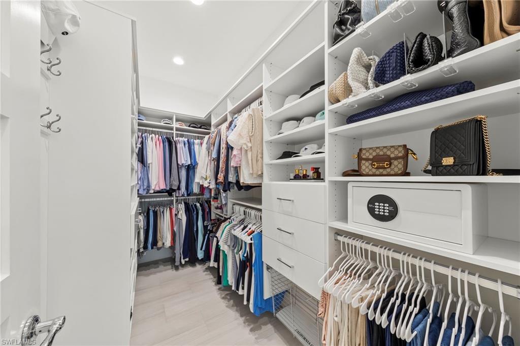 14785 Dockside Lane Naples, FL 34114 - Photo 17 of 50 View of walk in closet New OCCUPANCY SENSOR (December 2019), New CUSTOM CALIFORNIA CLOSET ORGANIZERS (February 2020)