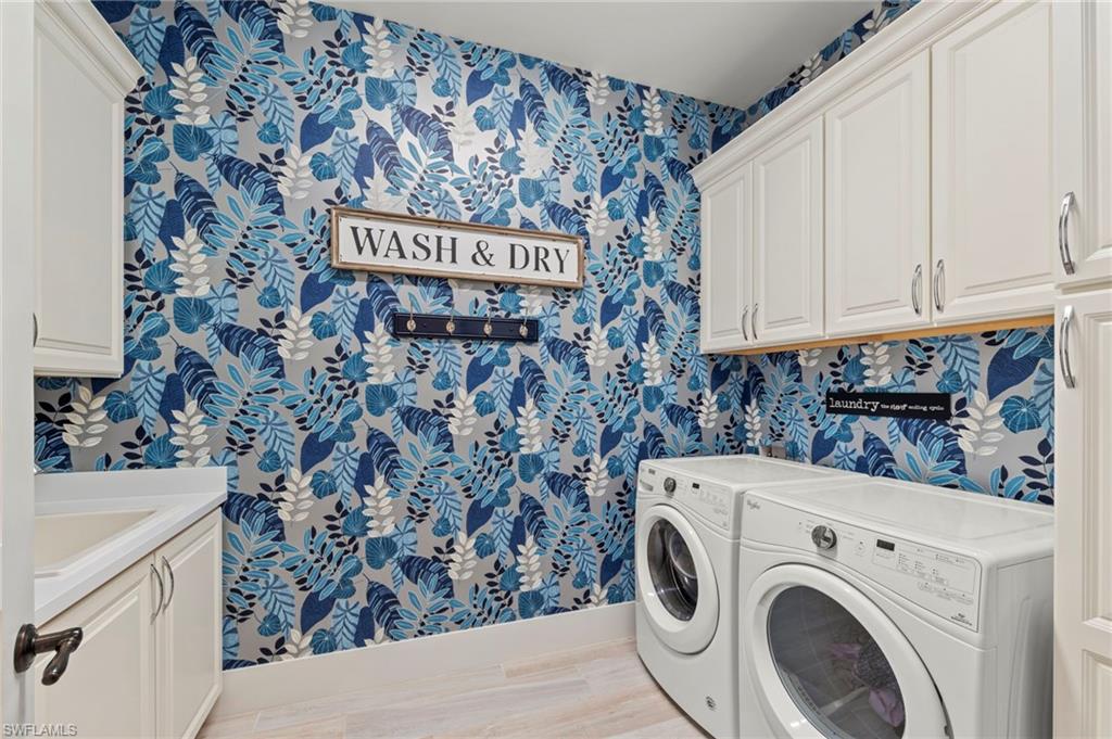 14785 Dockside Lane Naples, FL 34114 - Photo 27 of 50 Laundry room featuring wallpapered walls, cabinet space, washer and clothes dryer, and light wood-style floors New LIGHT FIXTURE (November 2018), New ECOBEE THERMOSTAT (December 2019), New OCCUPANCY SENSOR (December 2019), New WALLPAPER (June 2020)