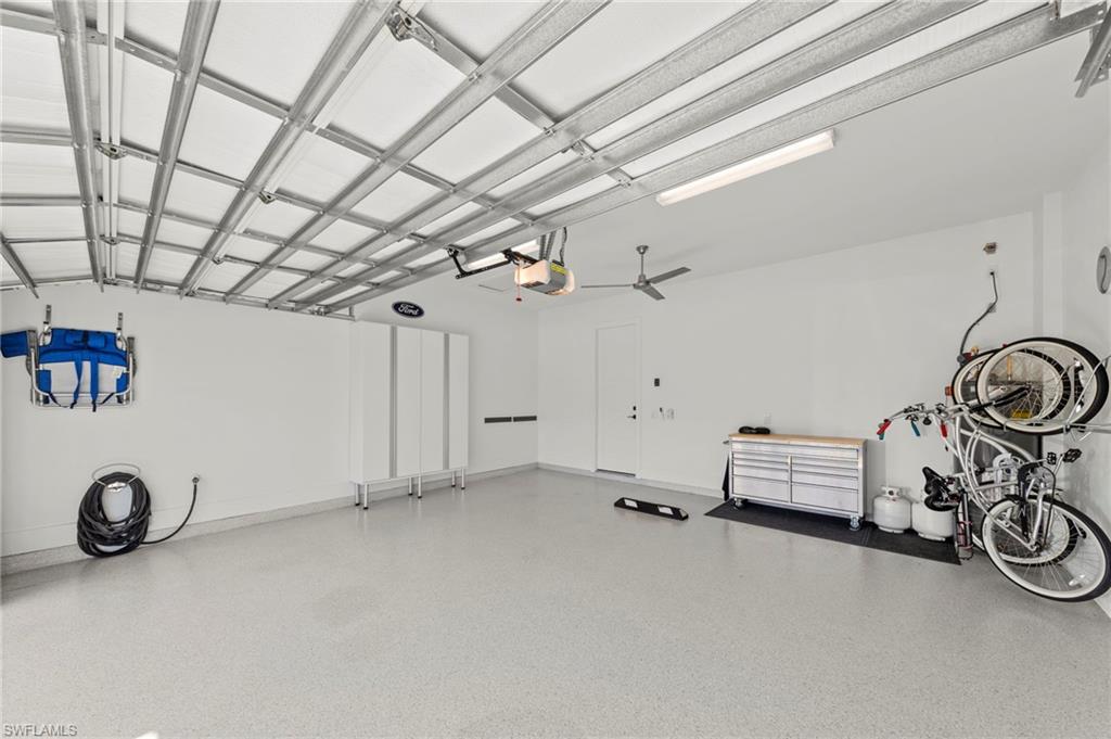 14785 Dockside Lane Naples, FL 34114 - Photo 28 of 50 Current bunk room can be converted back to a THIRD GARAGE BAY. Garage with a garage door opener New CEILING FAN (November 2018), New HEAVY DUTY EPOXY FLOOR (January 2019), New OVERHEAD DOOR & GARAGE ATTIC INSULATION (January 2019), New CUSTOM CALIFORNIA CLOSET STORAGE ORGANIZERS (February 2020), New HOT WATER RECIRCULATION PUMP (October 2022), New GARAGE INTERIOR PAINT (July 2023)
