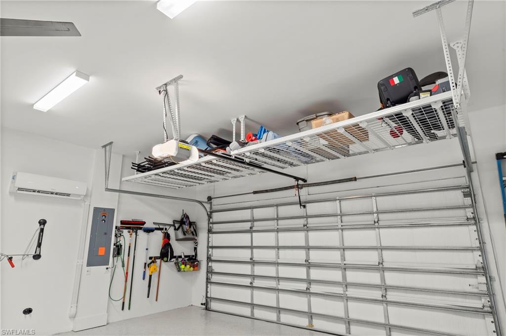 14785 Dockside Lane Naples, FL 34114 - Photo 29 of 50 Garage with electric panel, a mini split for heating / cooling, and a garage door opener New CEILING FAN (November 2018, New CEILING STORAGE SYSTEM (January 2019), New HEAVY DUTY EPOXY FLOOR (January 2019), New OVERHEAD DOOR & GARAGE ATTIC INSULATION (January 2019), New CUSTOM CALIFORNIA CLOSET ORGANIZER WALL (February 2020), New MINI-SPLIT AC (May 2020), New electrical panel SURGER PROTECTOR (October 2022), New GARAGE INTERIOR PAINT (July 2023)