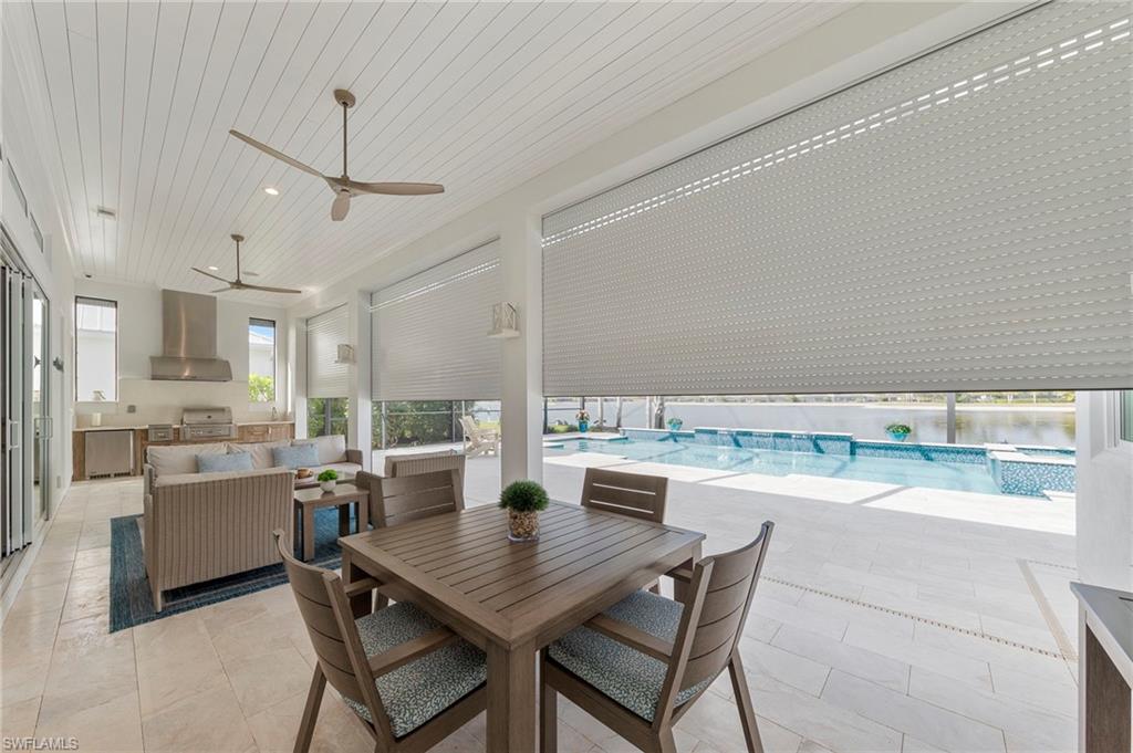 14785 Dockside Lane Naples, FL 34114 - Photo 34 of 50 Dining space featuring ceiling fan and wooden ceiling New OUTDOOR KITCHEN (December 2018), New electric Storm Smart HURRICANE SHUTTERS (March 2019), New SHIPLAP CEILING & CROWN MOLDING (May 2020), New CEILING FAN (October 2024)