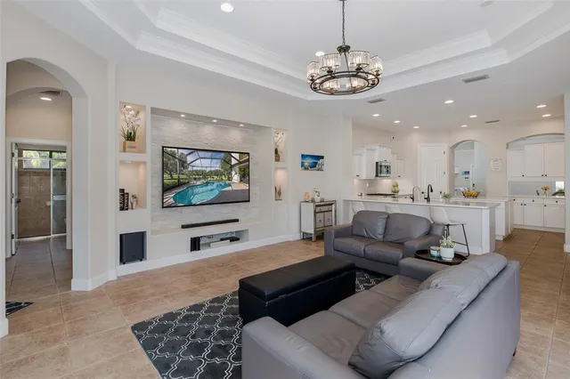 a view of a dining room with furniture a chandelier and wooden floor