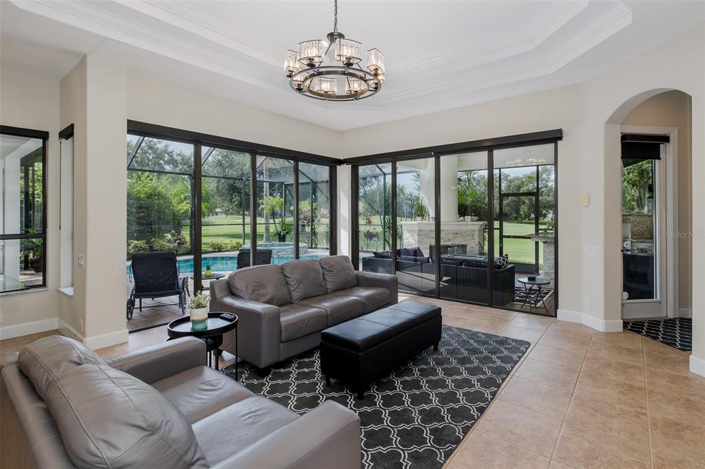1429 El Pardo Drive Trinity, FL 34655 - Photo 13 of 100 a living room with furniture and a floor to ceiling window