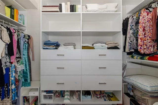 a living room with furniture a fireplace and a floor to ceiling window