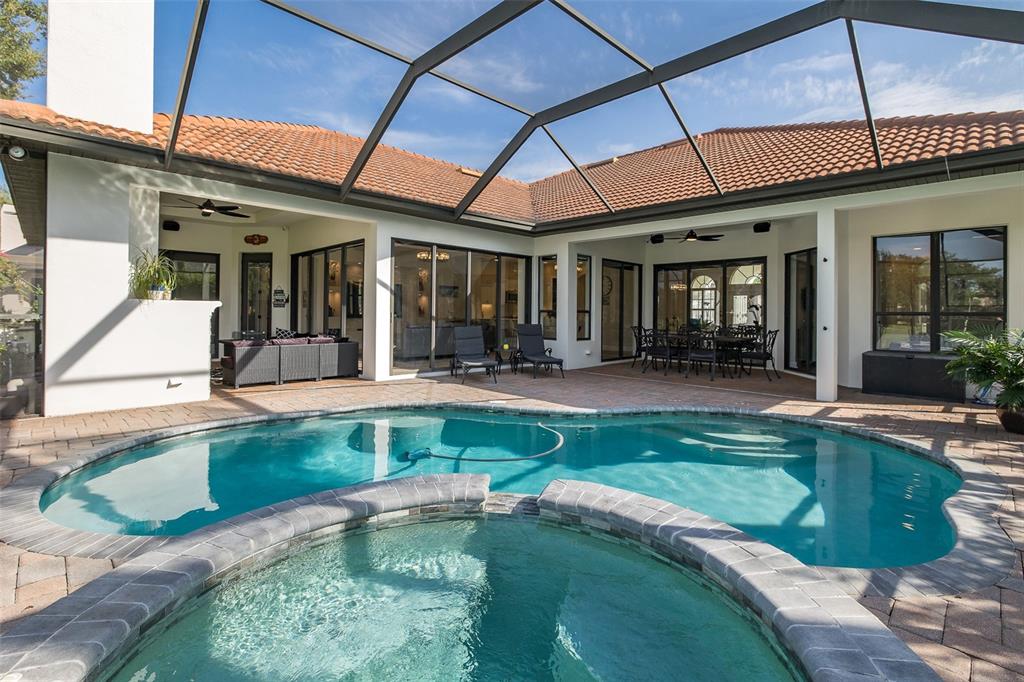 1429 El Pardo Drive Trinity, FL 34655 - Photo 3 of 100 a swimming pool with outdoor seating