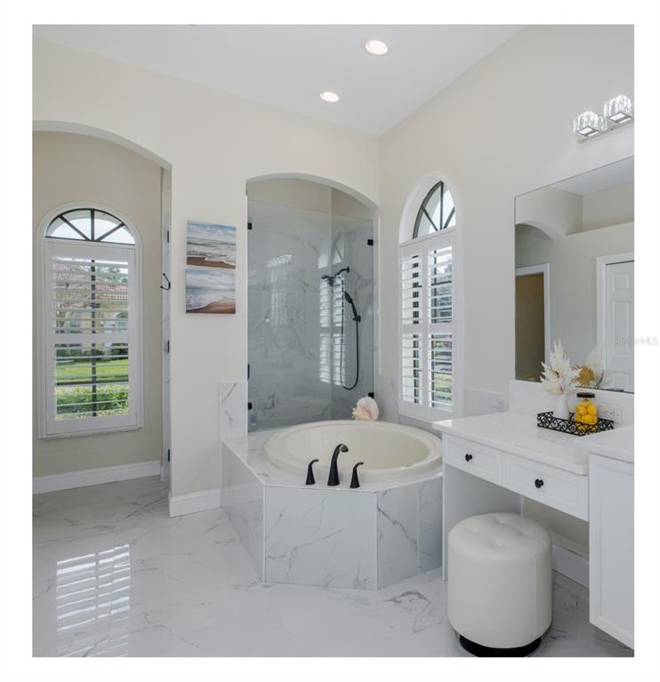 1429 El Pardo Drive Trinity, FL 34655 - Photo 31 of 100 a bathroom with a tub sink and mirror