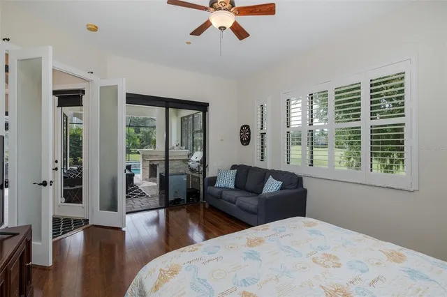a front view of a house with garden and trees