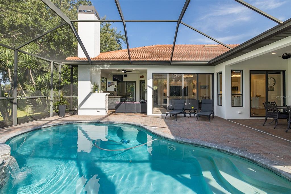 1429 El Pardo Drive Trinity, FL 34655 - Photo 57 of 100 a view of a patio with table and chairs under an umbrella