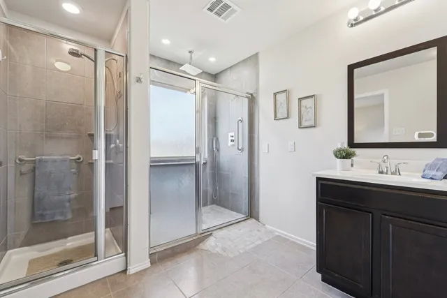 a bathroom with a glass shower door and a glass door