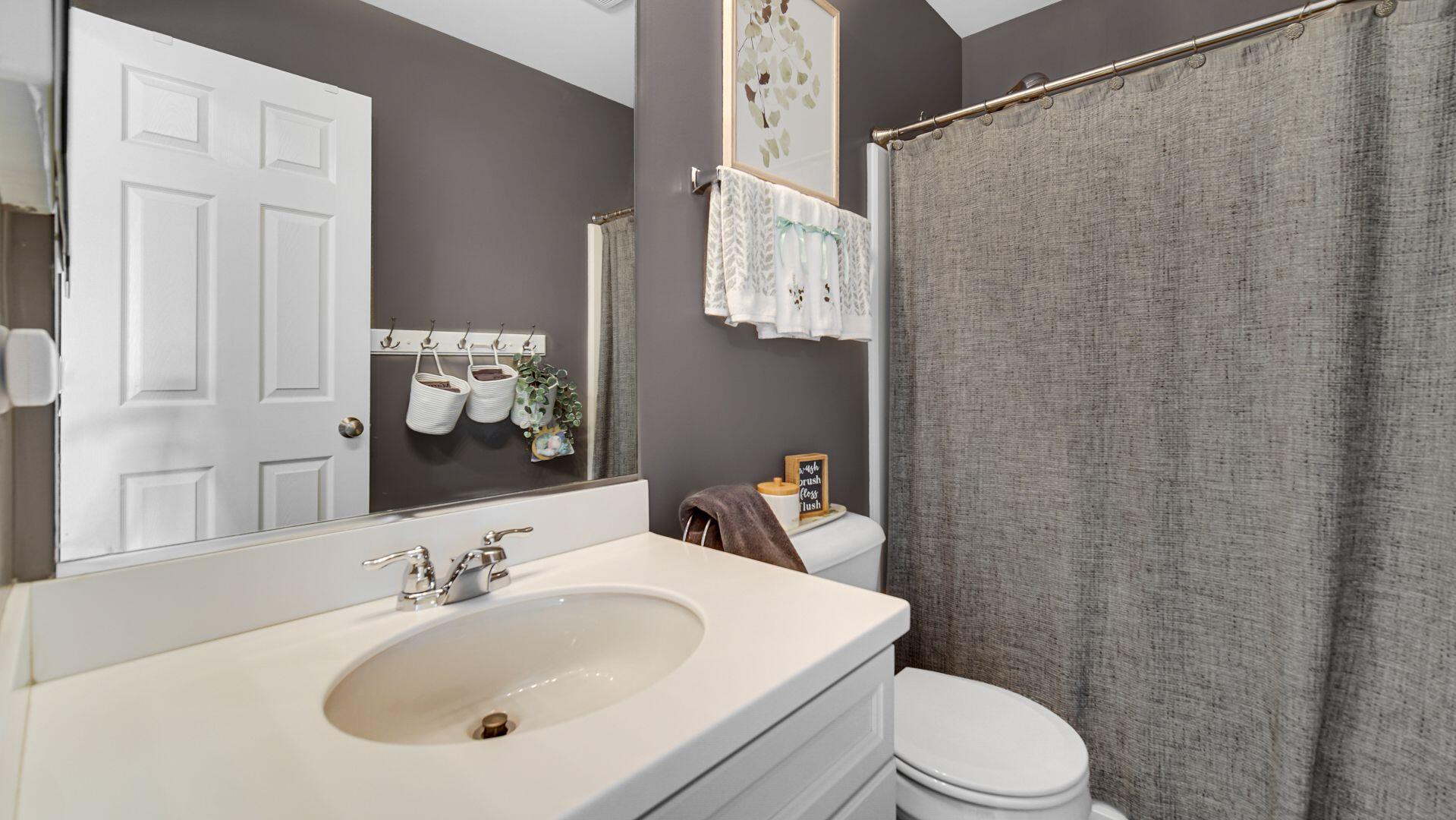 11175 Vermont Circle Crown Point, IN 46307 - Photo 15 of 22 a bathroom with a sink a toilet and shower curtain
