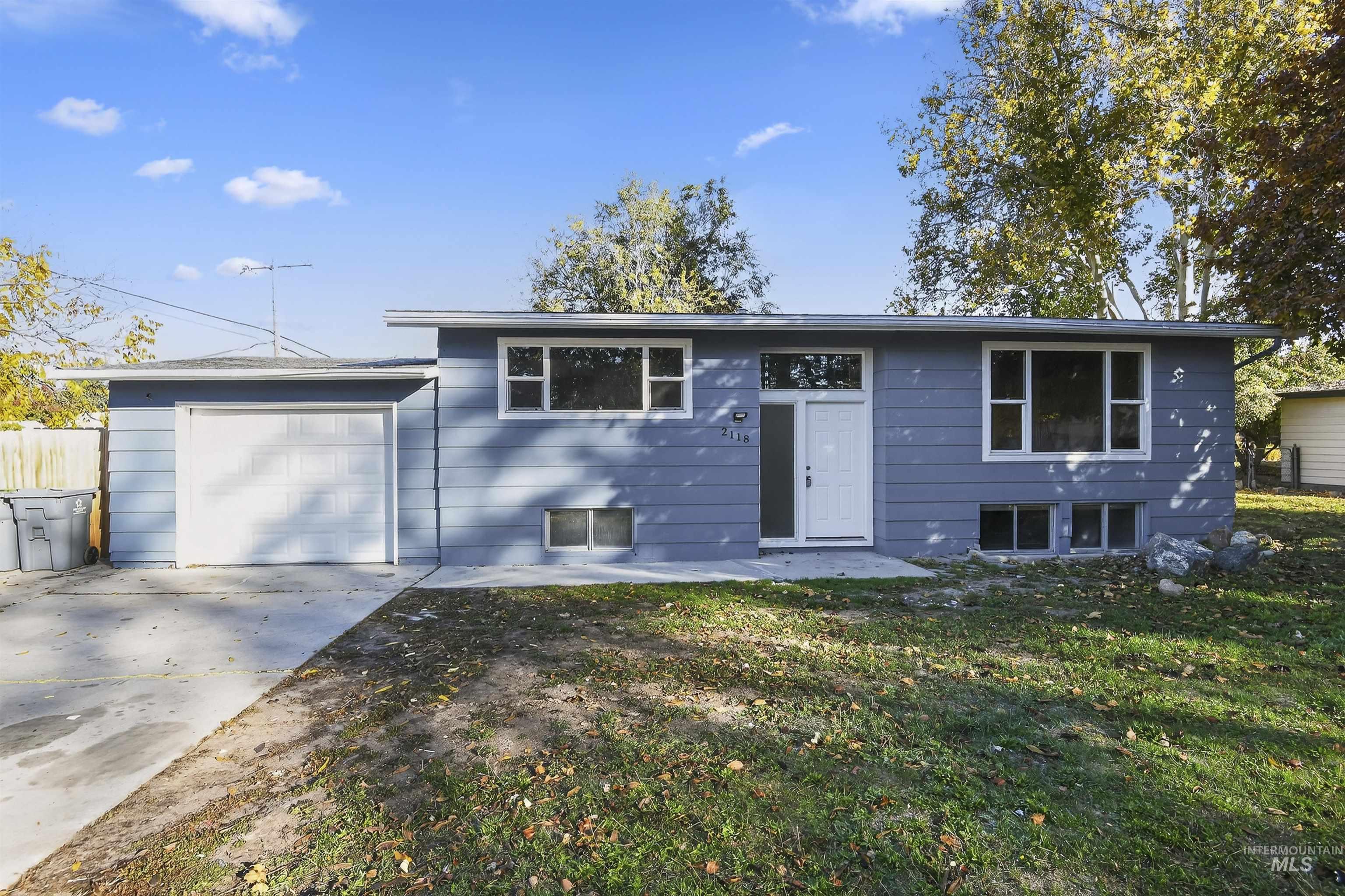 2118 West Targee Street Boise, ID 83705 - Photo 1 of 25 Split foyer home with a patio area, driveway, a front yard, and an attached garage