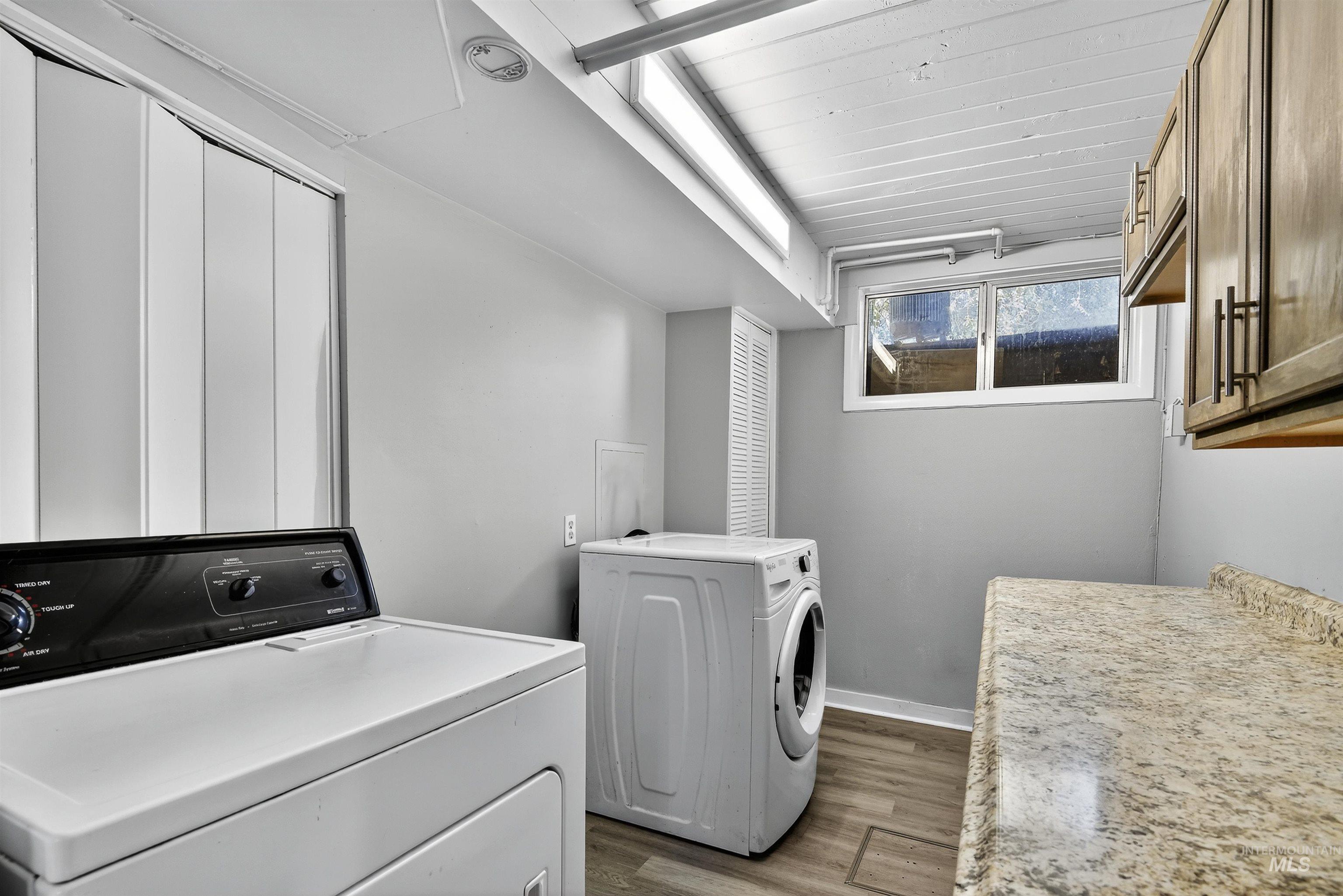 2118 West Targee Street Boise, ID 83705 - Photo 17 of 25 Laundry area featuring dark wood-type flooring, separate washer and dryer, and cabinet space