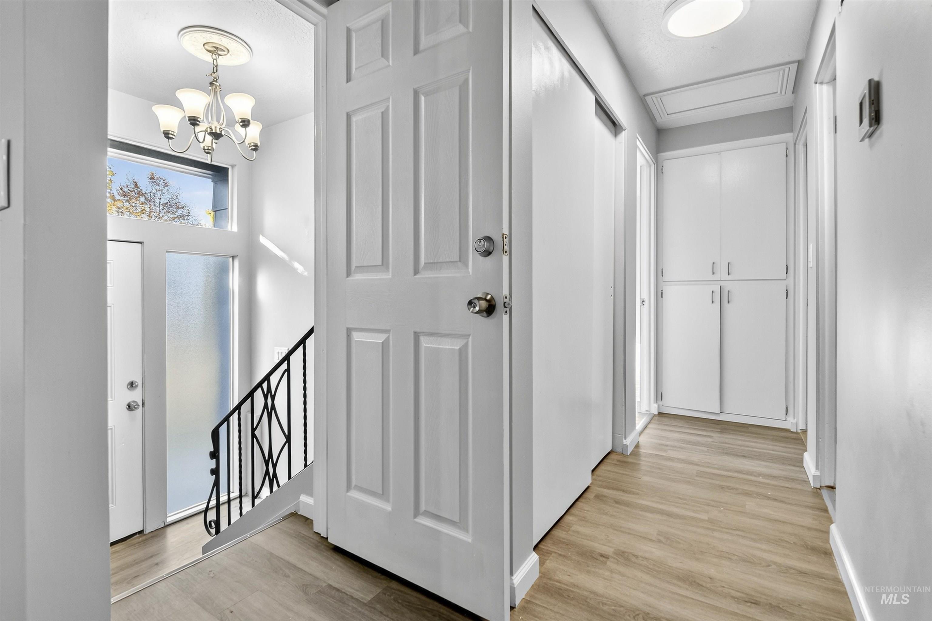 2118 West Targee Street Boise, ID 83705 - Photo 3 of 25 Hall featuring light wood-style floors and a chandelier