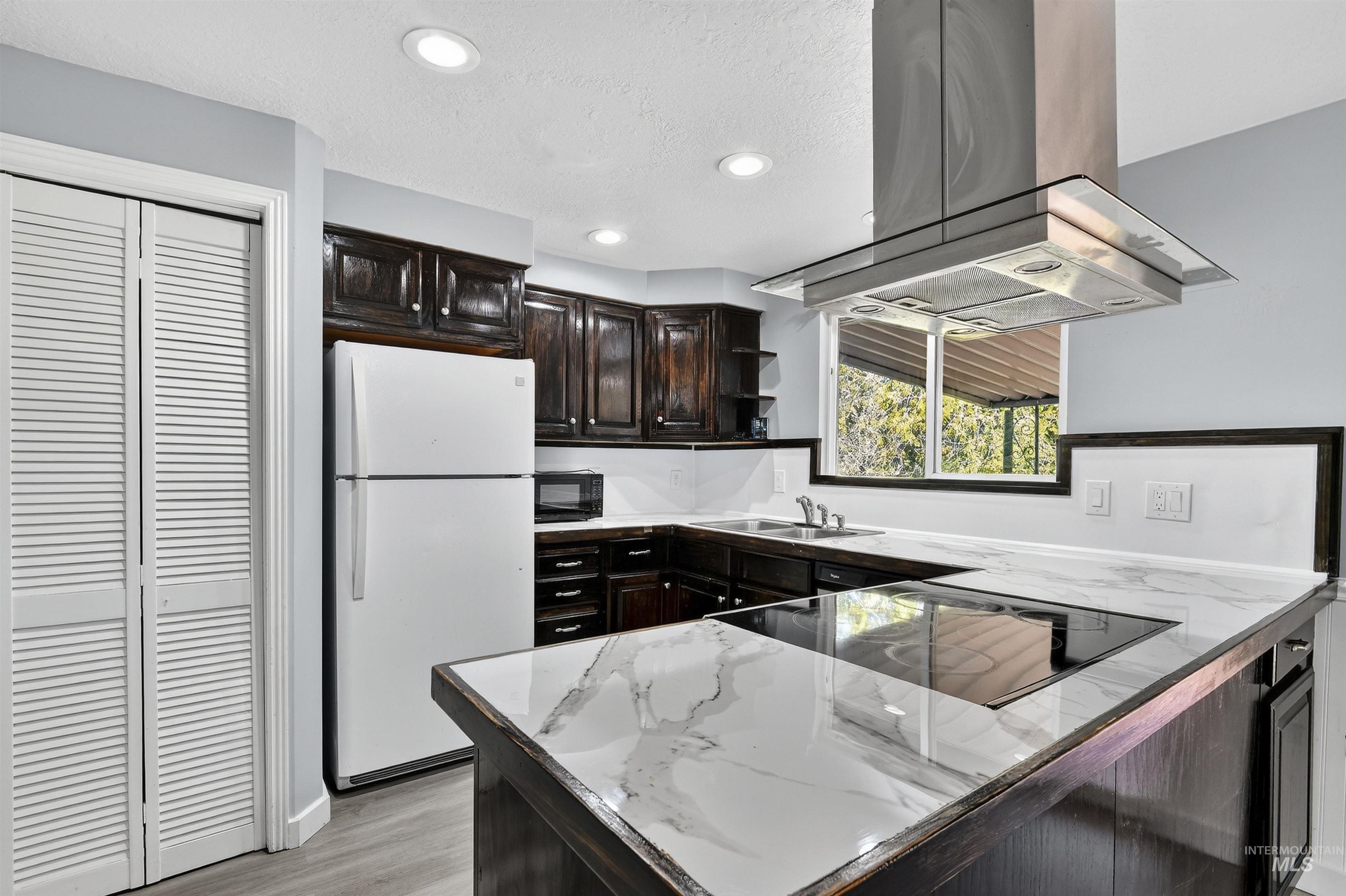 2118 West Targee Street Boise, ID 83705 - Photo 7 of 25 Kitchen featuring open shelves, black appliances, island exhaust hood, recessed lighting, and light wood-style floors