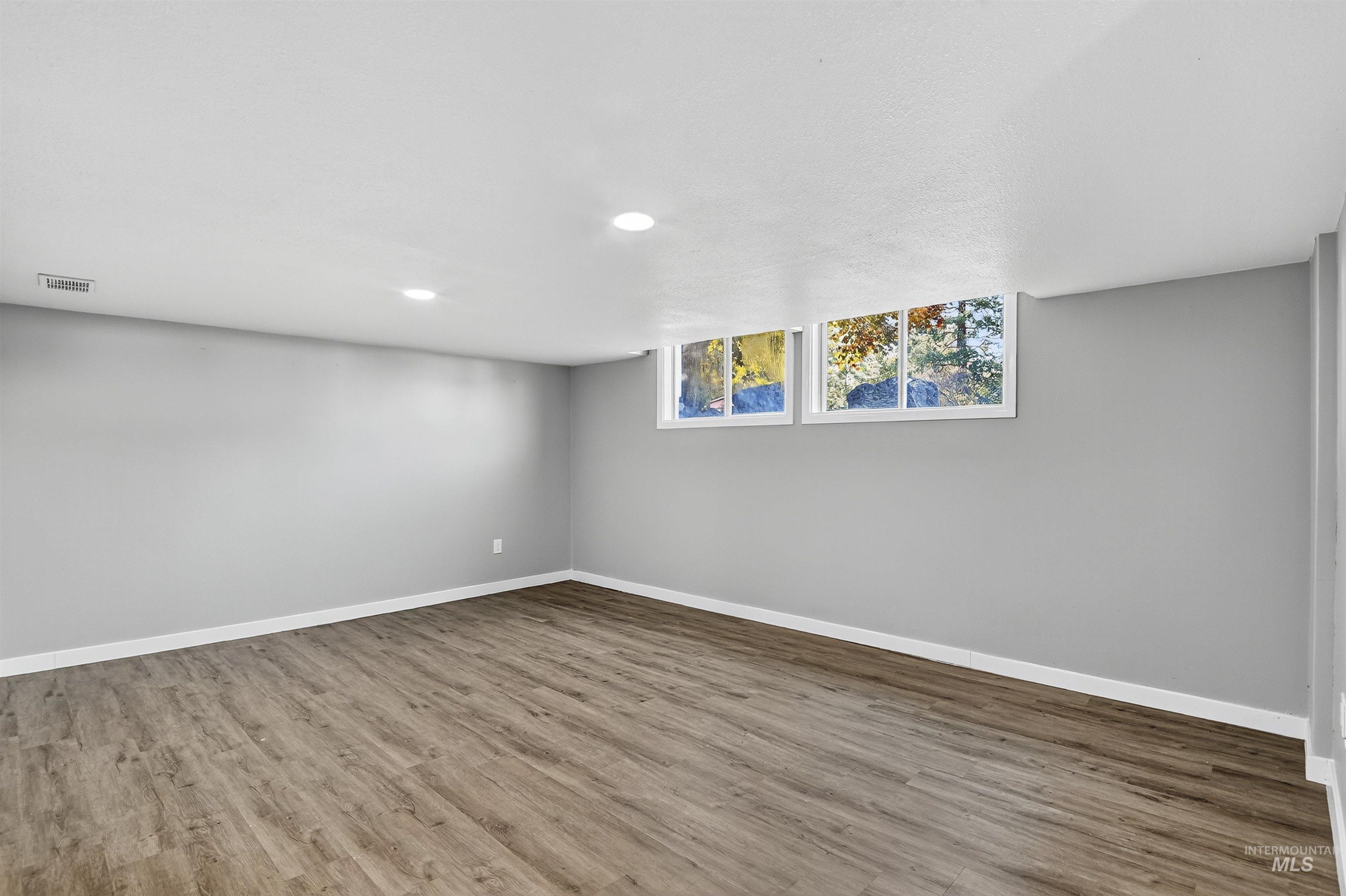 2118 West Targee Street Boise, ID 83705 - Photo 8 of 25 Unfurnished room featuring wood finished floors and recessed lighting