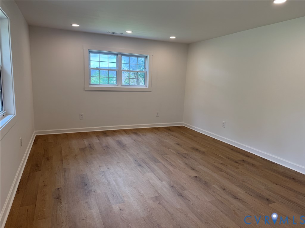 8207 Sebera Road Prince George, VA 23875 - Photo 11 of 27 Bright, open room featuring warm wood-finish floor