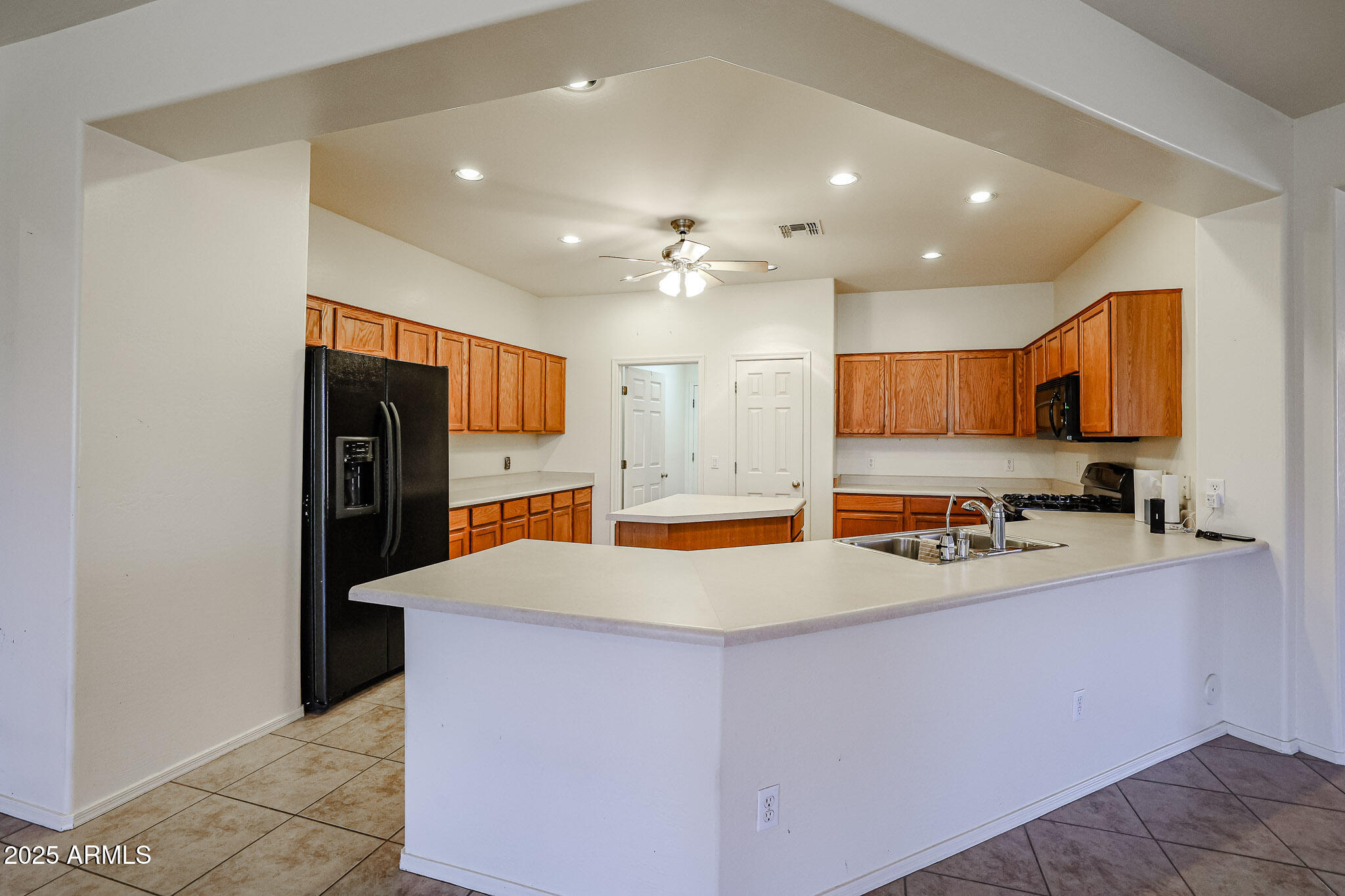 16617 North 40th Drive Phoenix, AZ 85053 - Photo 12 of 15 a large kitchen with stainless steel appliances a large counter top oven a refrigerator and a sink