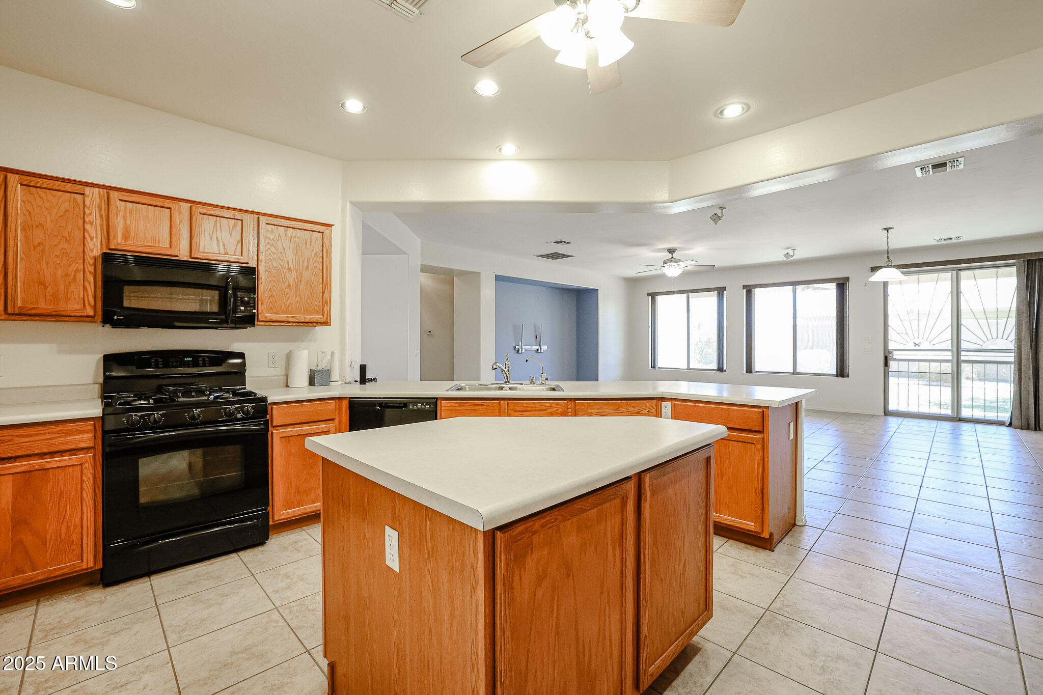 16617 North 40th Drive Phoenix, AZ 85053 - Photo 3 of 15 a kitchen with stainless steel appliances granite countertop a stove top oven a sink dishwasher and a refrigerator with wooden floor